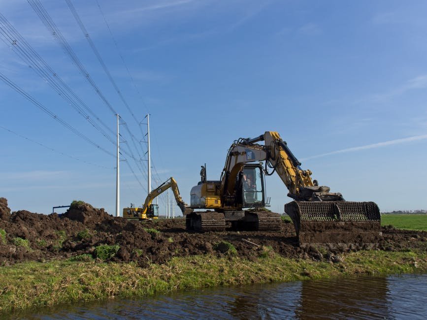 Excavator placing dug soil into a pile on a construction site
