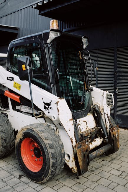 Mini excavator and skid steer shaping soil on a residential plot