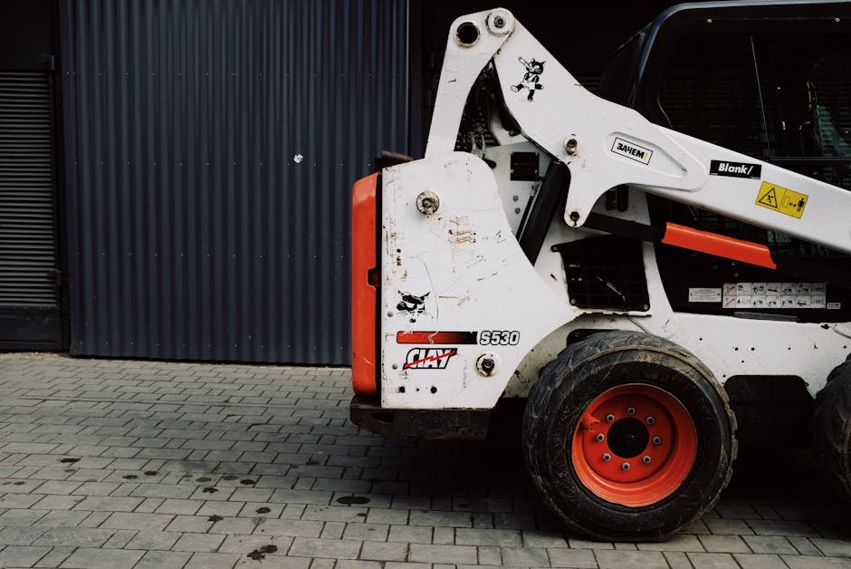 Bobcat leveling a yard base for driveway or patio preparation