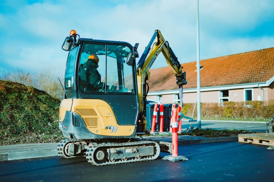 Mini excavator working in a residential garden, showing a typical small property digging job